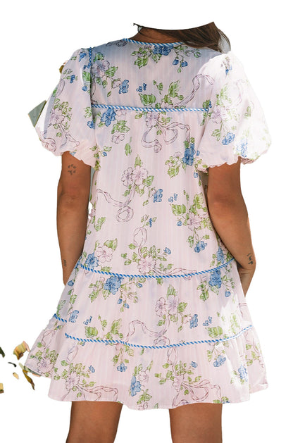 Back view of a LuckeLadybug pink floral mini dress with puff sleeves and tiered design