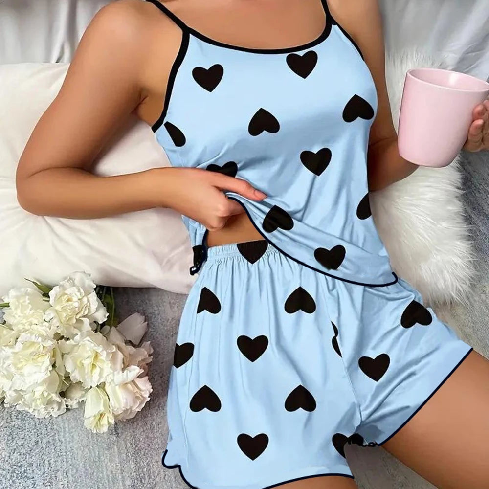 Blue pajama set with black heart print for a cozy night in, featuring comfortable shorts and a tank top