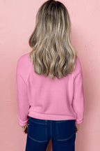 Back view of pink sweater by LuckeLadybug, perfect for holiday cheer with a white MERRY Christmas sweater style