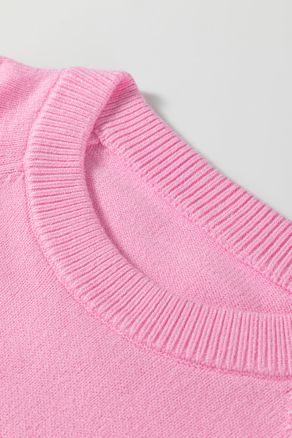 Soft pink sweater by LuckeLadybug, perfect for festive occasions with a white MERRY Christmas sweater design.