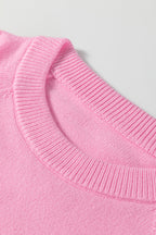 Soft pink sweater by LuckeLadybug, perfect for festive occasions with a white MERRY Christmas sweater design.