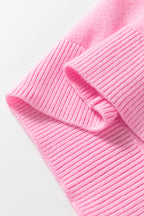 Close-up of a ribbed pink sweater featuring warm fabric, perfect for cozy winter wear