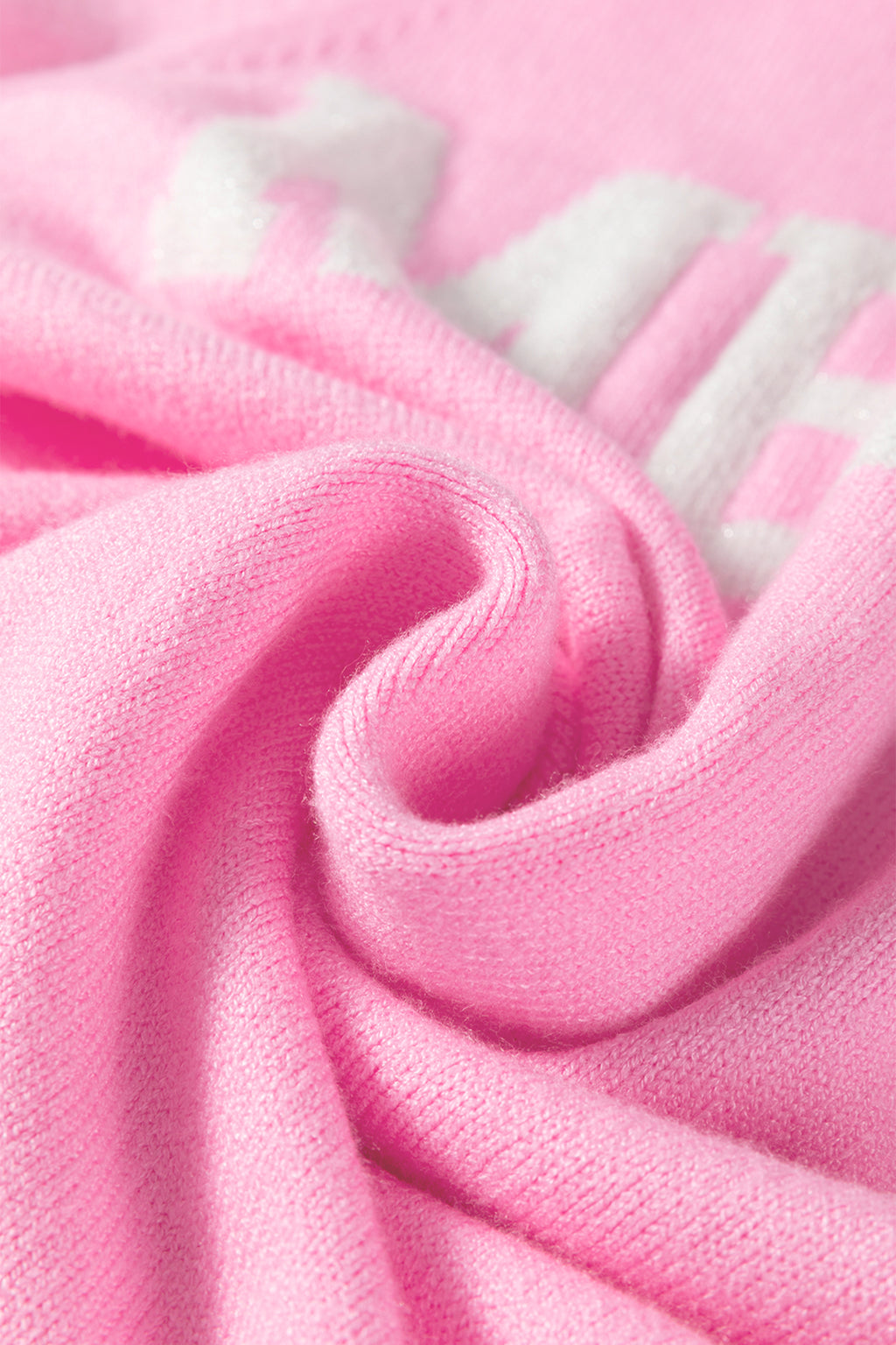 Pink LuckeLadybug white MERRY Christmas sweater fabric detail showing soft texture and cozy feel