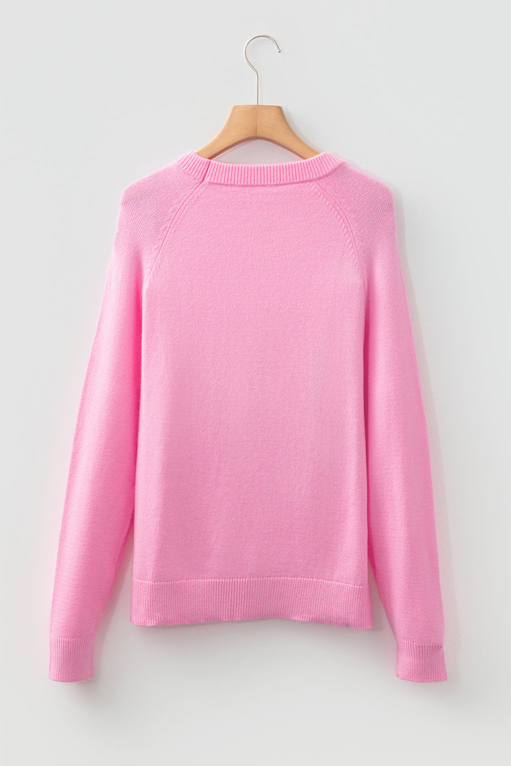 Pink sweater from LuckeLadybug featuring a cozy design, perfect for the holiday season
