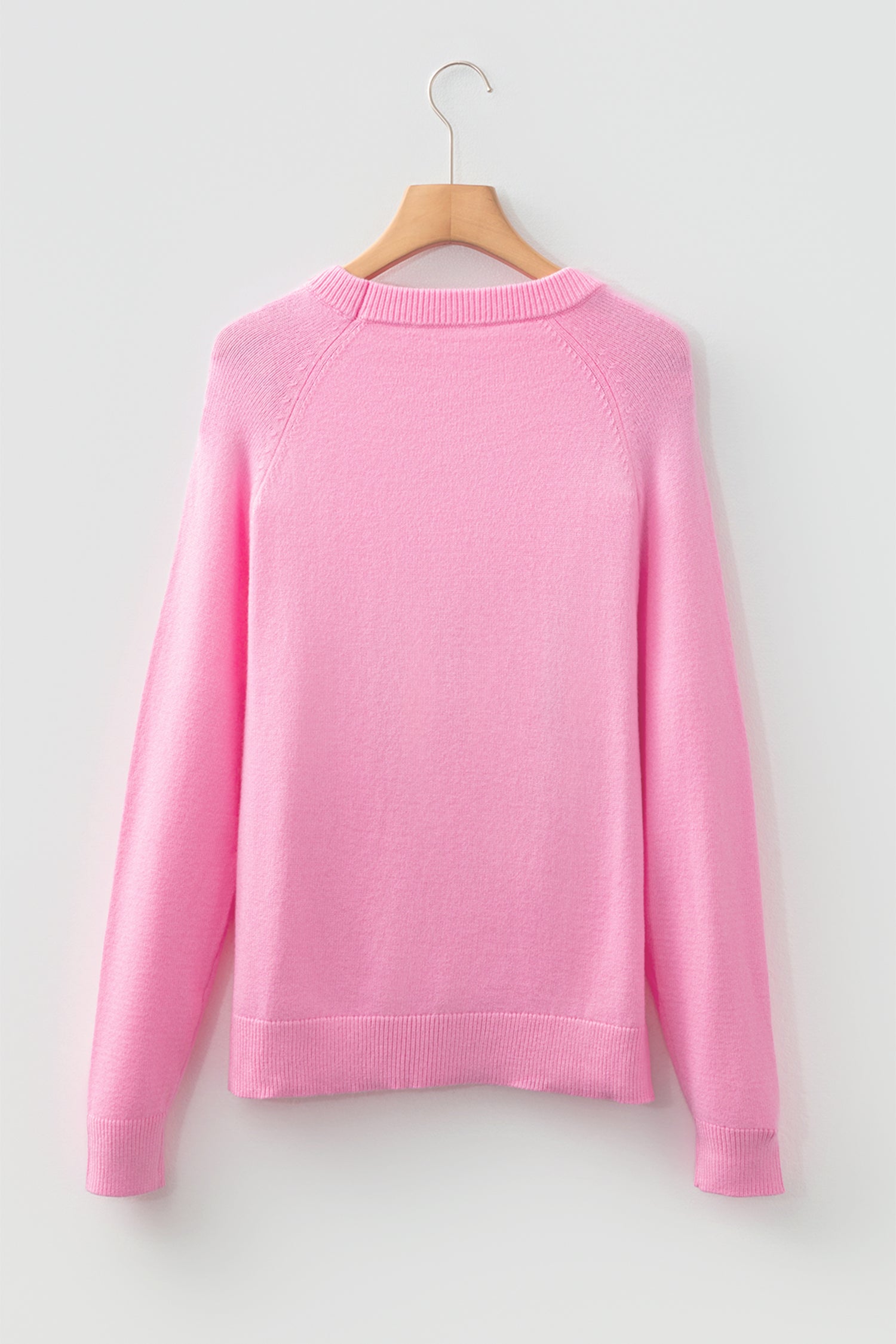 Pink sweater from LuckeLadybug featuring a cozy design, perfect for the holiday season