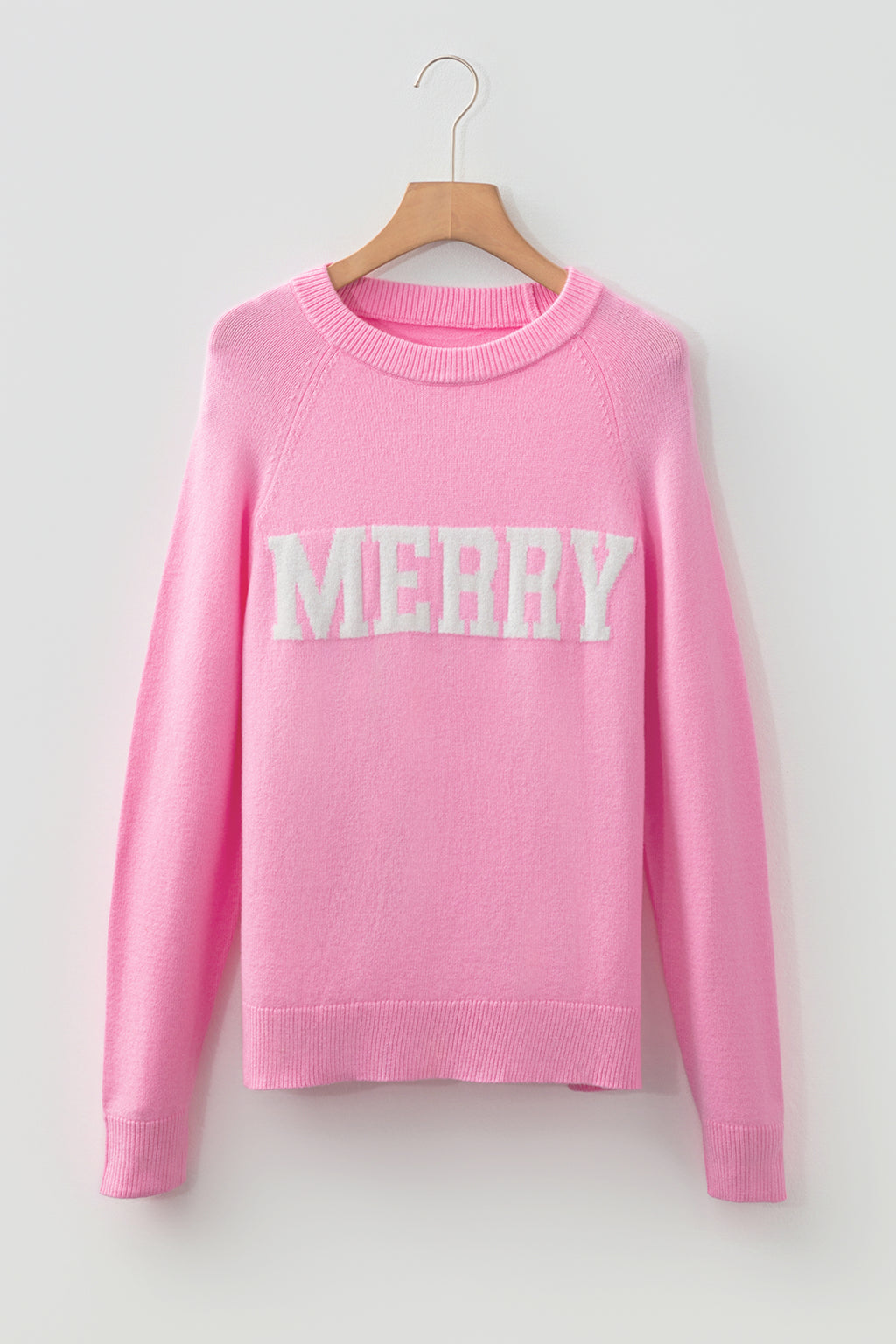 LuckeLadybug pink sweater featuring white MERRY Christmas sweater design for festive style