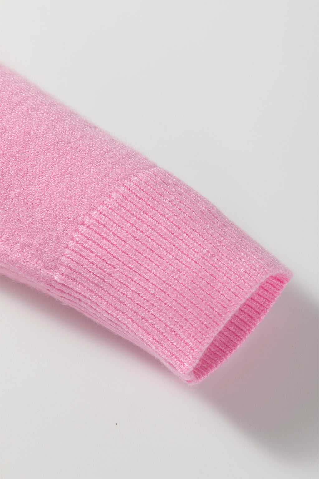 Pink sweater sleeve detail from LuckeLadybug featuring a cozy design perfect for holiday wear
