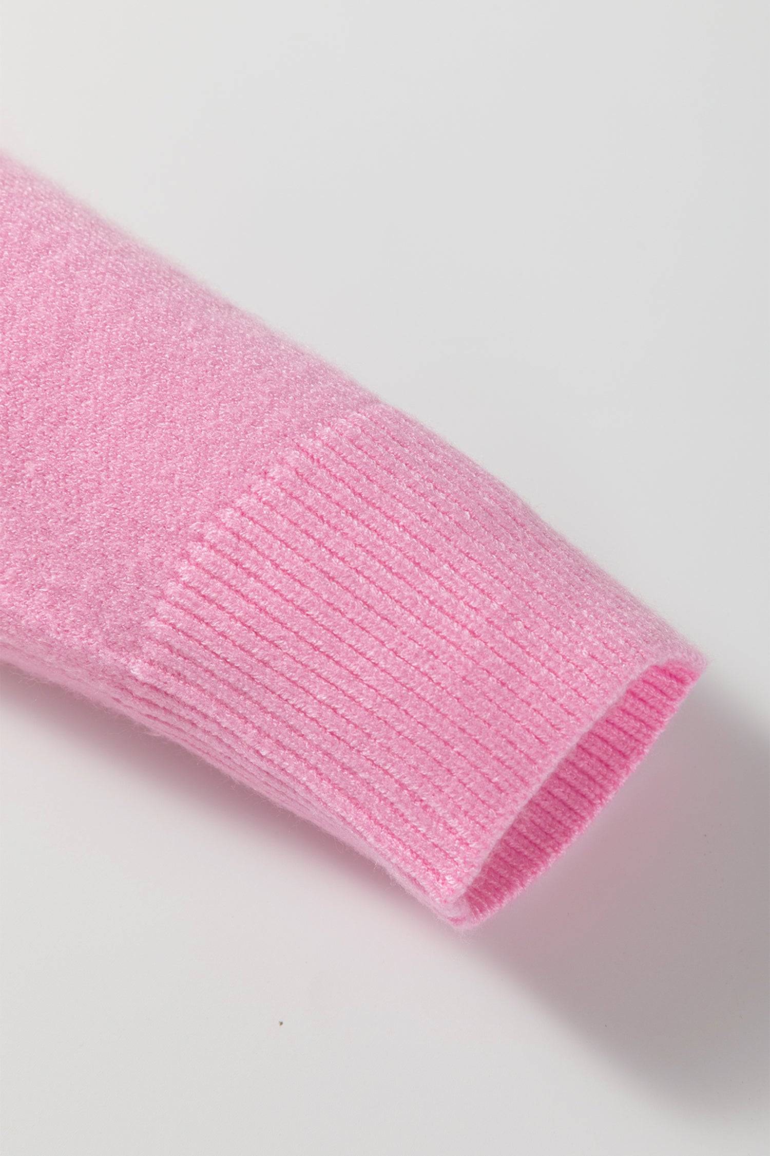 Pink sweater sleeve detail from LuckeLadybug featuring a cozy design perfect for holiday wear