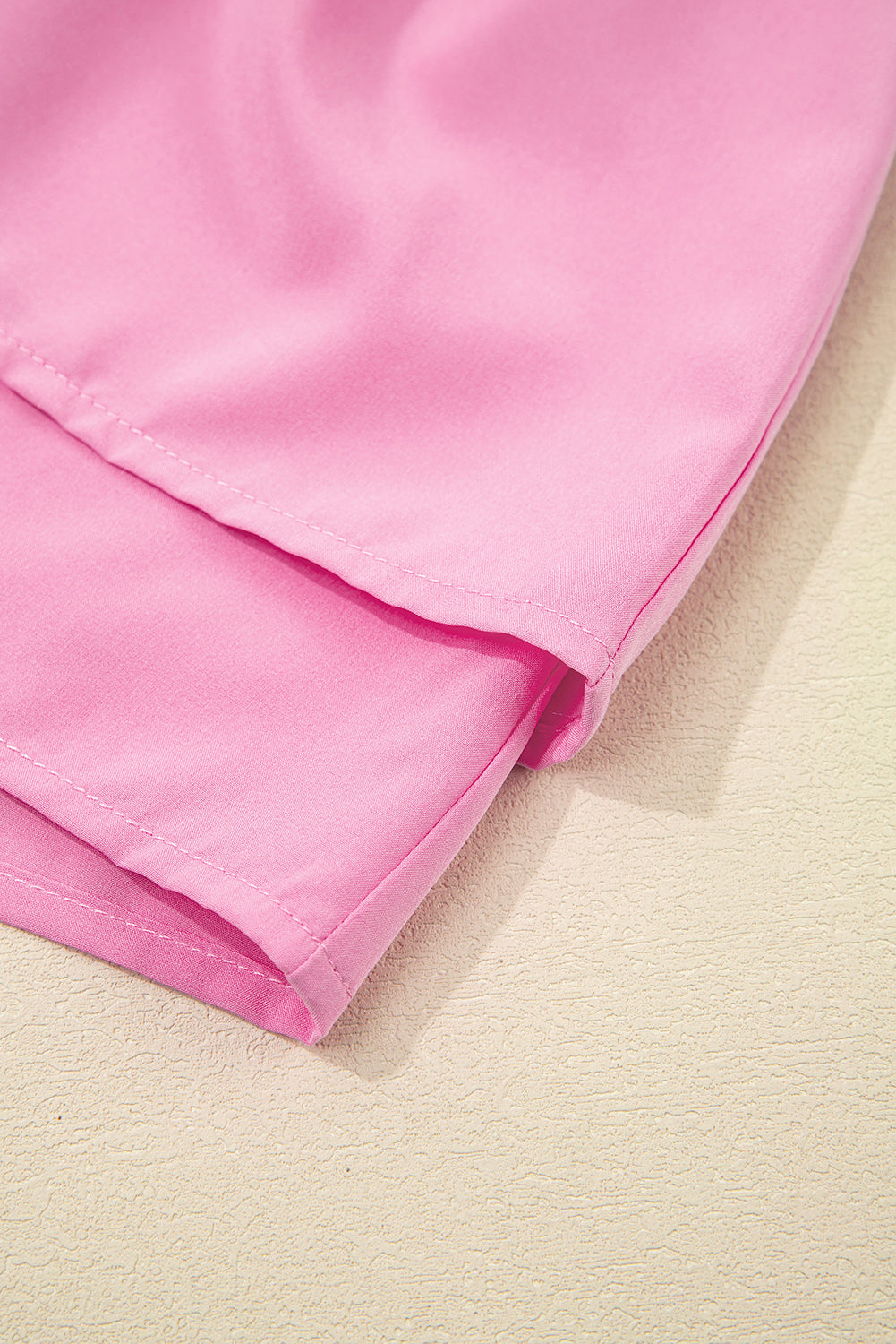 Close-up of pink shorts dress showcasing soft fabric and clean hem for stylish comfort