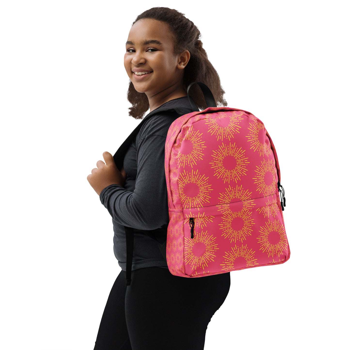 Girl smiling while wearing a pink stylish backpack with a floral design for school or outdoor activities