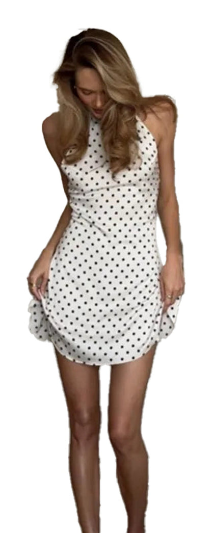 Model wearing a polka dot halter mini dress, showcasing the stylish design and flattering fit