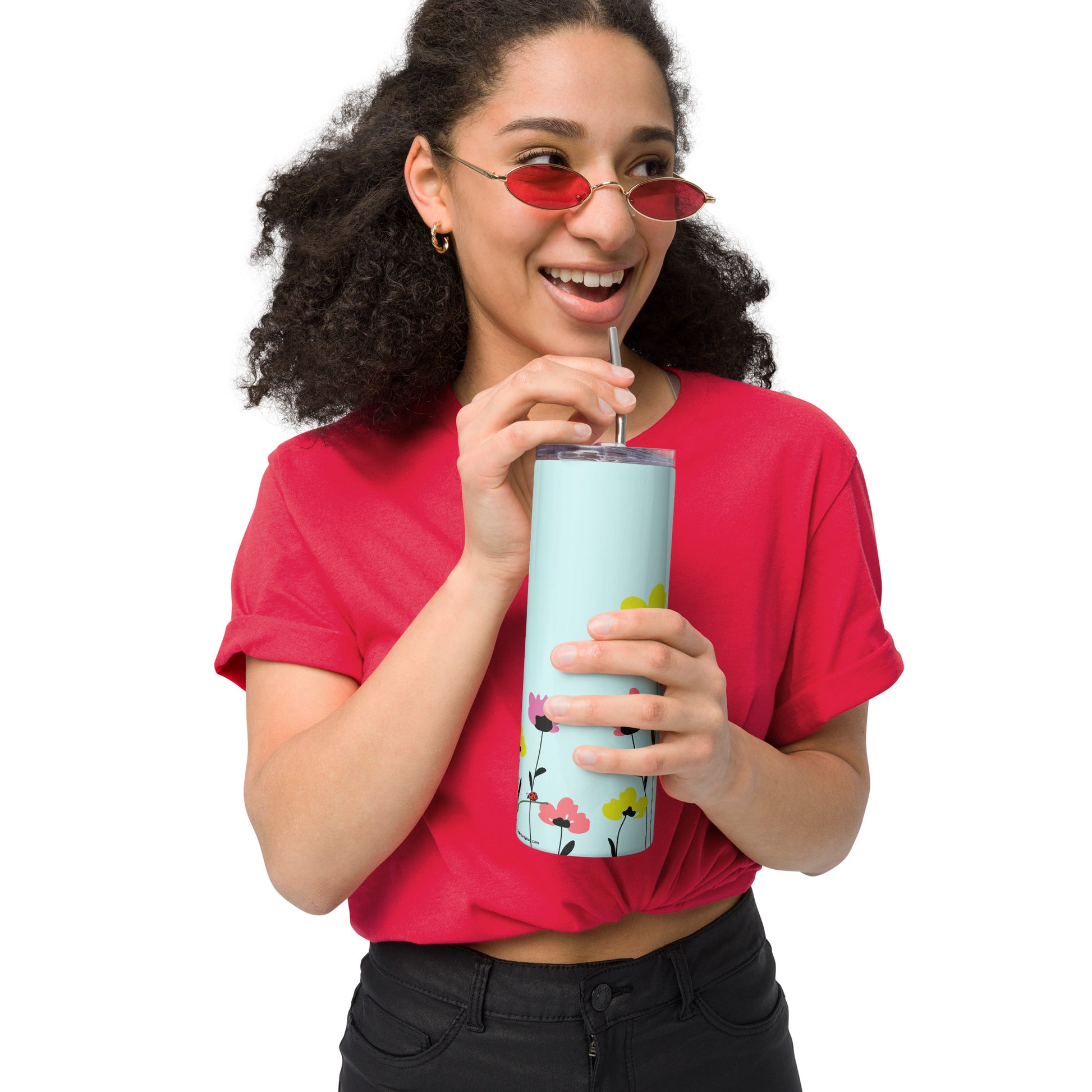 Woman in red shirt holding a pretty floral tumbler with straw made of stainless steel