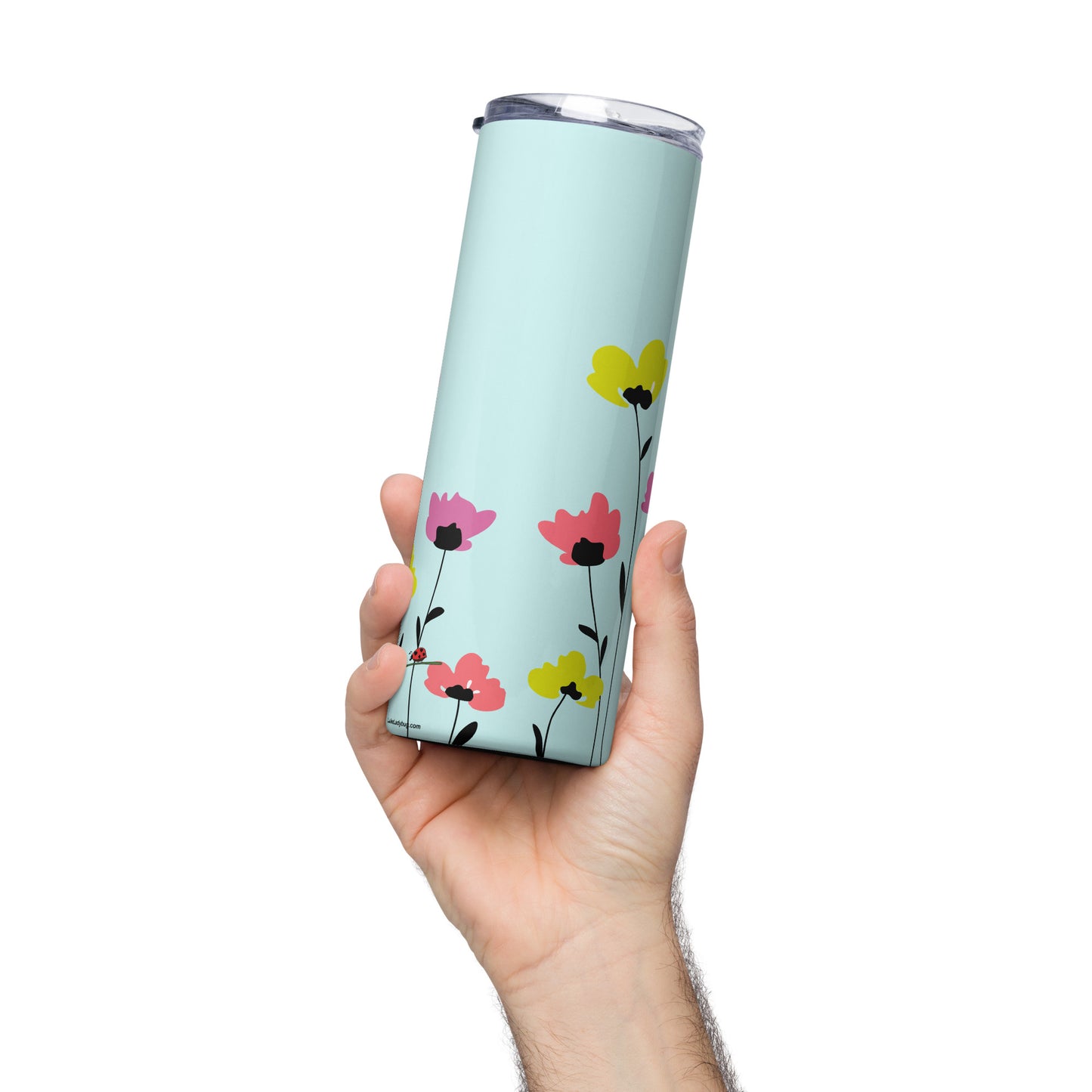 Pretty floral tumbler with straw in blue stainless steel held in hand featuring colorful flower design