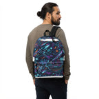A man wearing a brown sweatshirt and dark pants is shown from the back, wearing a backpack with a vibrant, colorful futuristic graphic print featuring neon lights, circuit boards, and stylized characters.