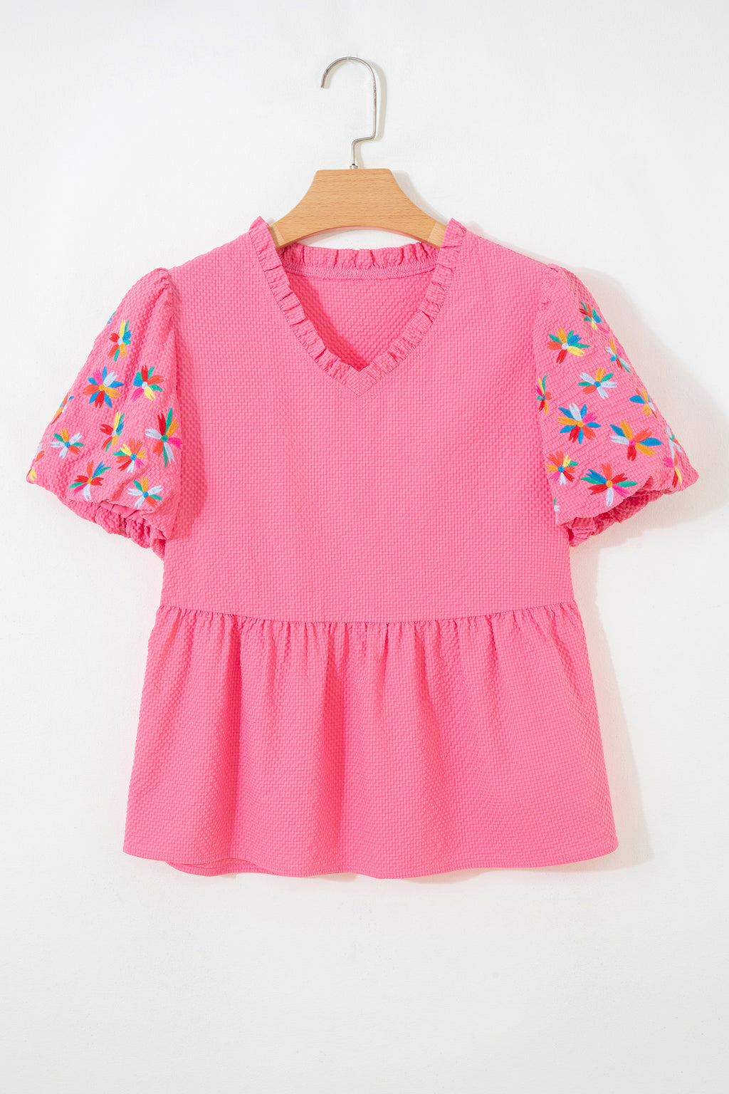 Pink puff sleeve blouse with colorful floral embroidery and ruffled neckline, perfect for casual wear