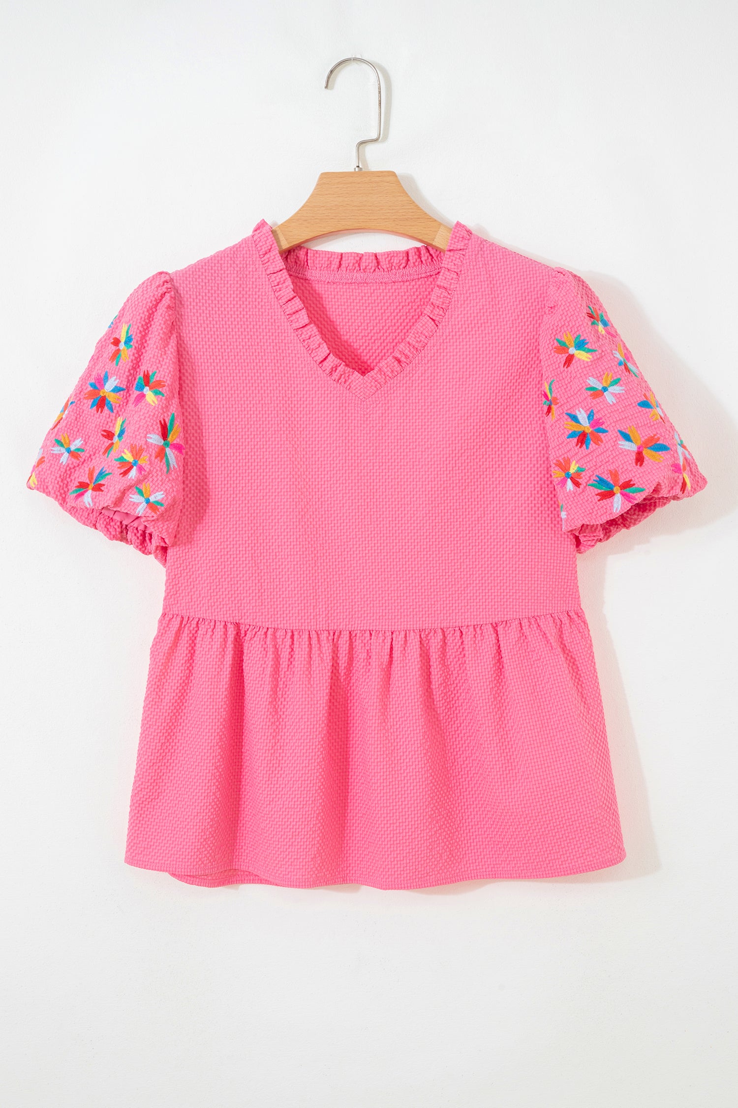 Pink puff sleeve blouse with colorful floral embroidery and ruffled neckline, perfect for casual wear