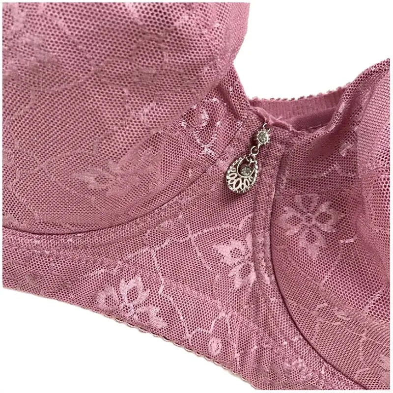 Pink lace push up bra from LuckeLadybug LLC with decorative charm and delicate floral design