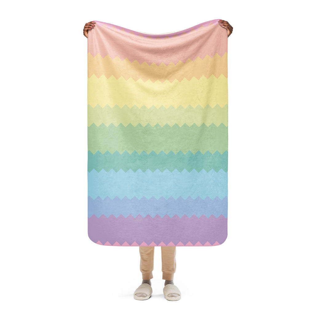 LuckeLadybug rainbow pride sherpa blanket with pastel zigzag stripes held by person