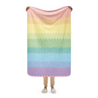 LuckeLadybug rainbow pride sherpa blanket with pastel zigzag stripes held by person