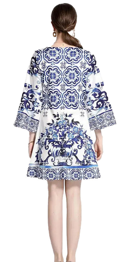 Back view of a LuckeLadybug LLC fit and flare red and white porcelain mini dress with intricate patterns