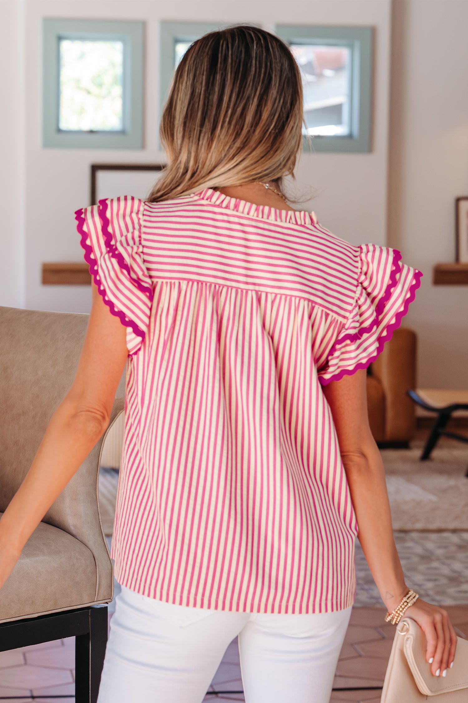 Back view of a red and white striped blouse with ruffle sleeves from LuckeLadybug LLC