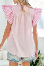 Back view of a red and white striped blouse with pink ruffled sleeves, styled with denim shorts