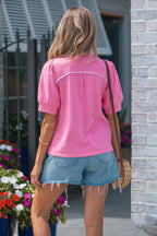 Back view of a pink blouse with puffed sleeves and casual style, perfect for summer wear.