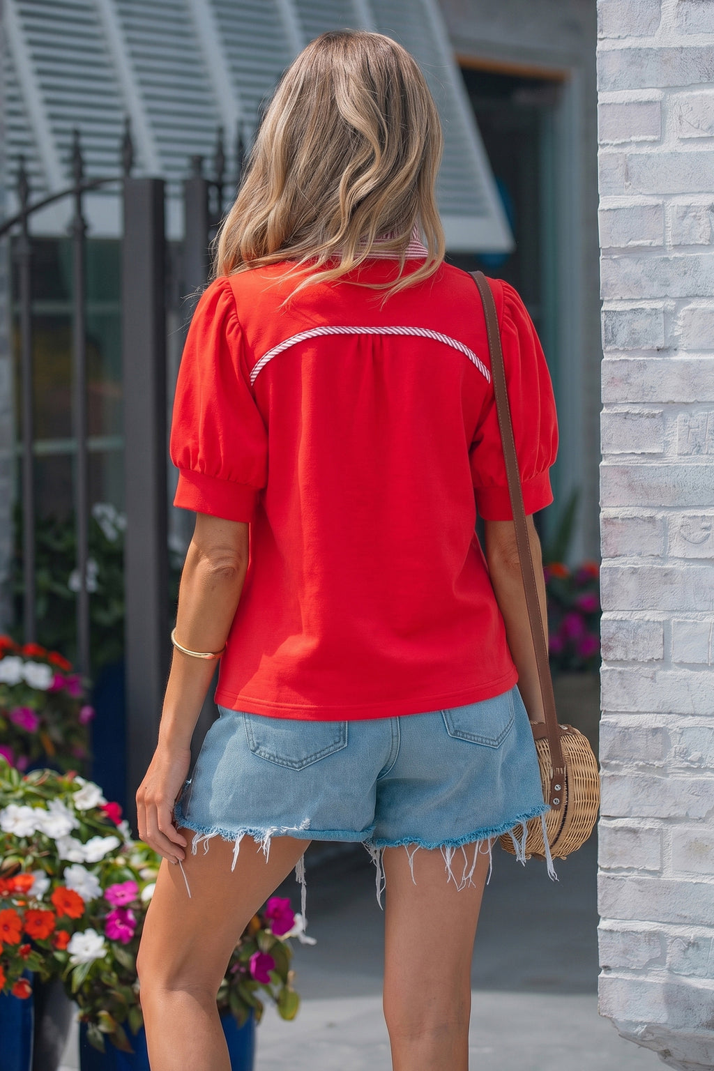 Back view of a stylish red and white striped blouse paired with denim shorts, perfect for casual wear