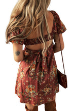 Back view of a red floral mini dress by LuckeLadybug with tie detail and short sleeves