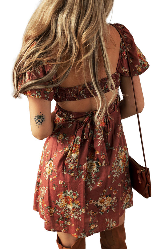 Back view of a red floral mini dress by LuckeLadybug with tie detail and short sleeves