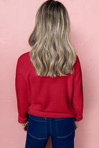 Red sweater with a casual fit, perfect for pairing with jeans, featuring a white MERRY Christmas sweater design.