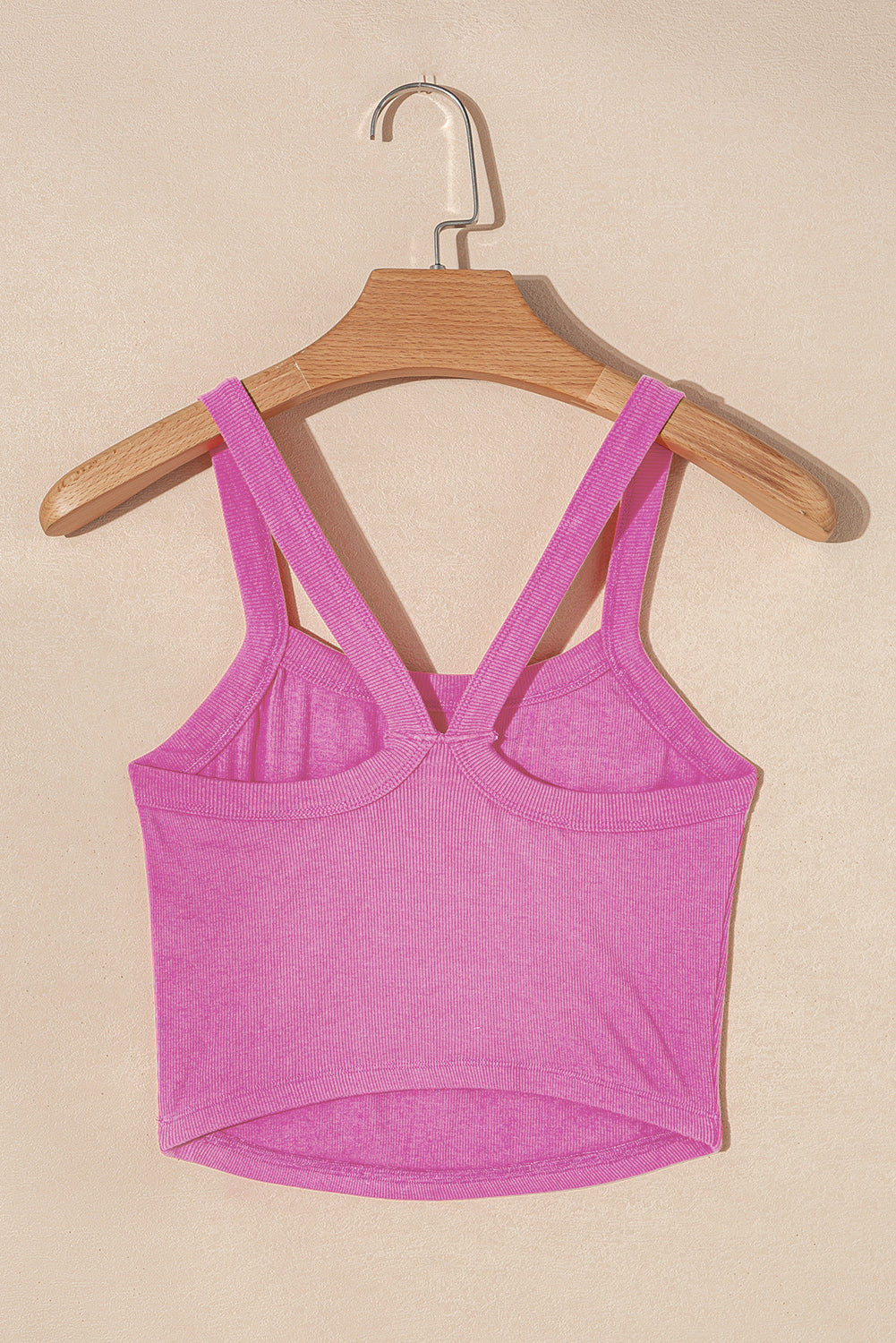 LuckeLadybug ribbed cropped cami top in bright pink with double shoulder straps hanging on wooden hanger
