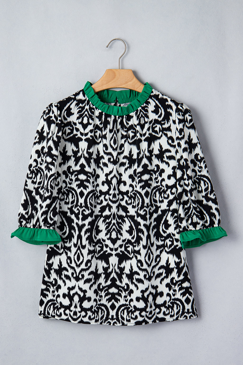 LuckeLadybug ruffled blouse in black and white damask print with green trim sleeves