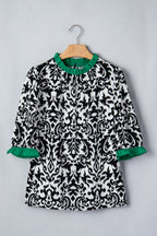 LuckeLadybug ruffled blouse in black and white damask print with green trim sleeves