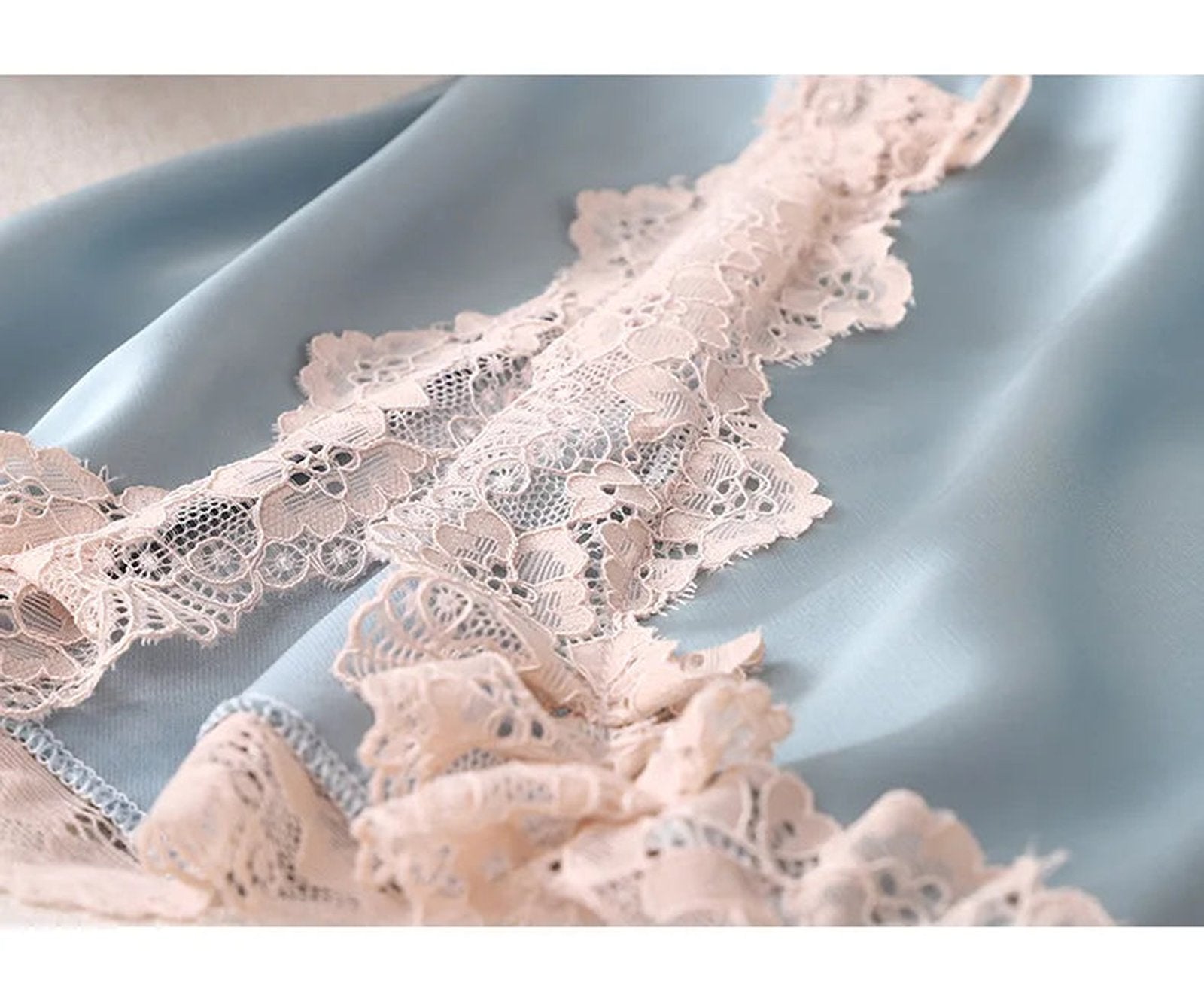 Elegant satin spaghetti strap nightgown with delicate lace detailing in soft blue and pink
