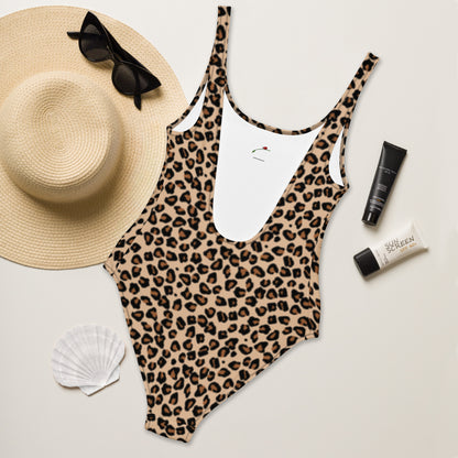 LuckeLadybug leopard print one-piece swimsuit flat lay with straw hat sunglasses sunscreen and shell