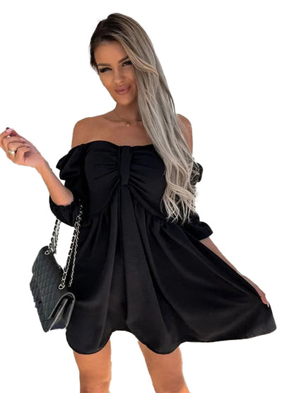 Model wearing a sexy off shoulder mini dress in black, with a fitted bodice and flowing skirt