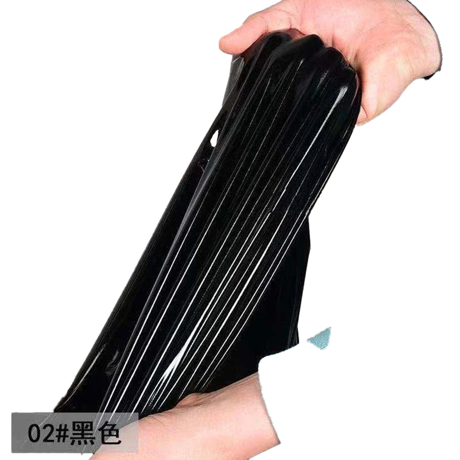 Hand holding a stretchy sexy patent leather mermaid dress showcasing its flexible material in black