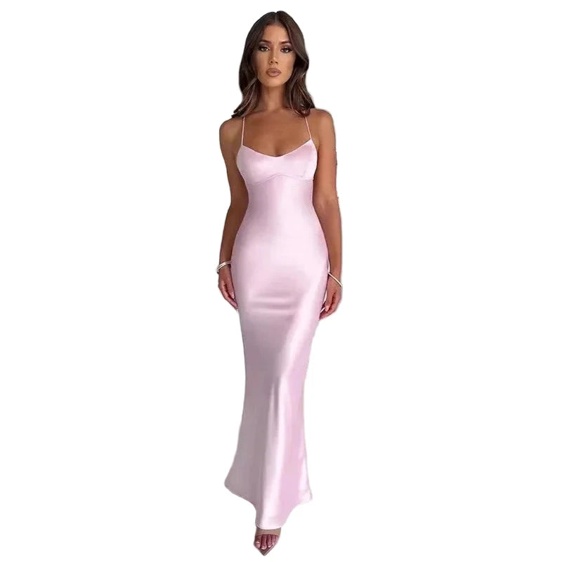 Elegant model wearing a sexy satin evening gown in soft pink, perfect for formal occasions