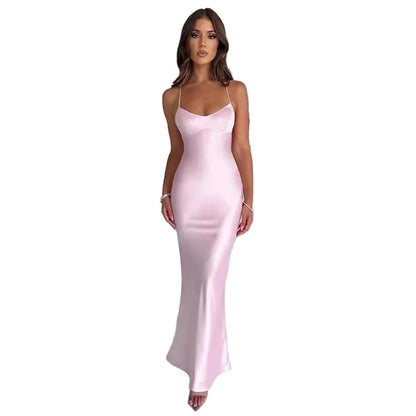 Elegant model wearing a sexy satin evening gown in soft pink, perfect for formal occasions