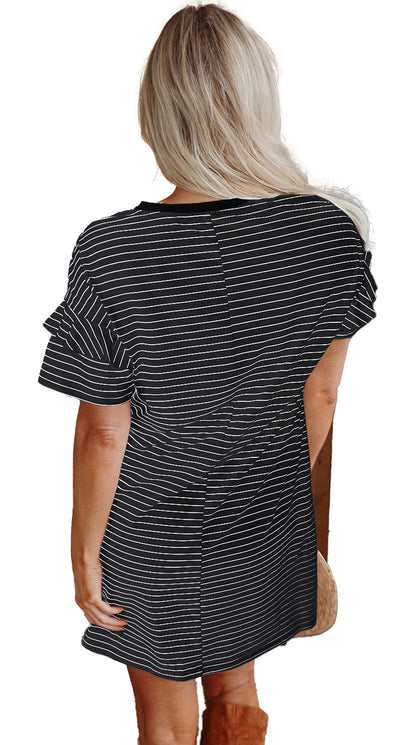 Back view of woman in black stripe ruffle mini dress with short ruffle sleeves and relaxed H line fit