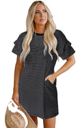 LuckeLadybug H Line model wearing a black stripe ruffle mini dress with pockets holding straw hat