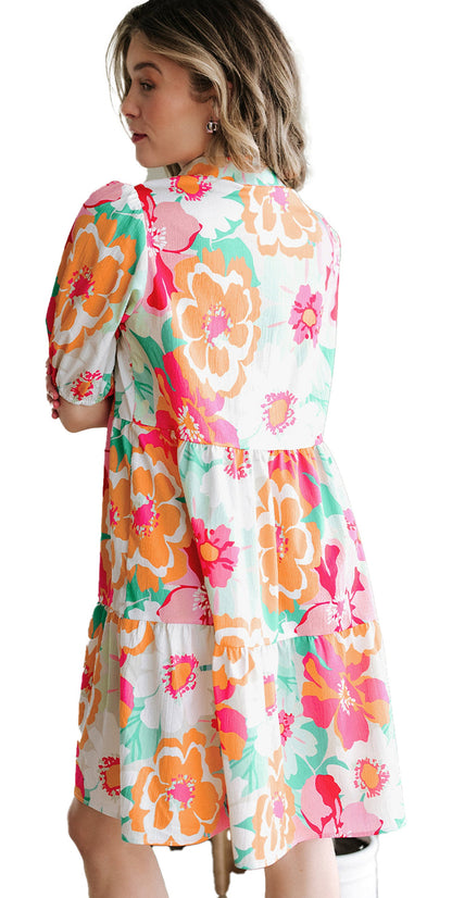 Back view of woman wearing LuckeLadybug green floral babydoll dress A line tiered skirt and puff sleeves