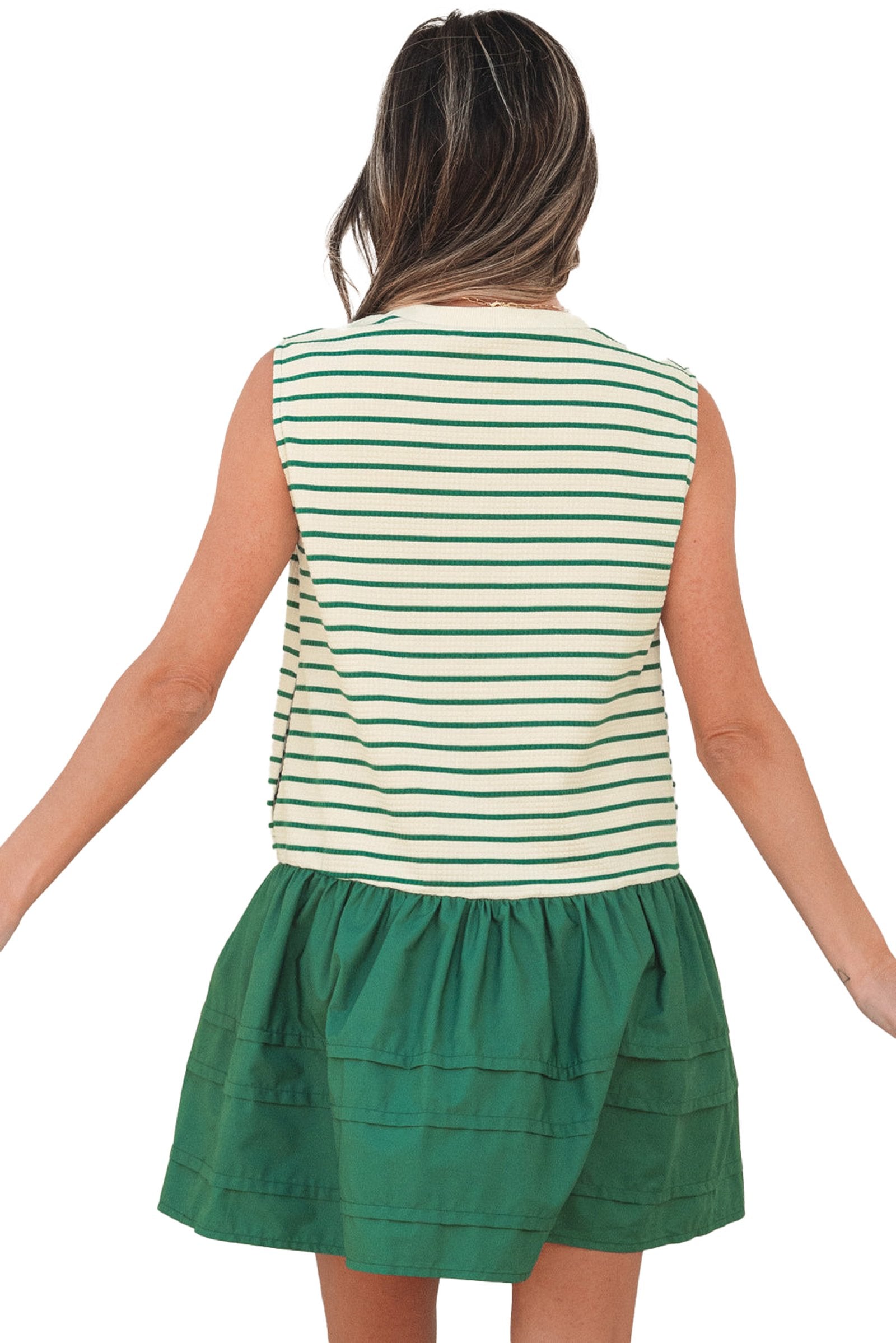 Back view of model wearing green stripe ruffle mini dress with sleeveless striped top and green ruffle skirt