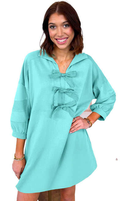 LuckeLadybug moonlight jade bow front mini dress on smiling model with three bows and relaxed fit