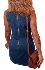 Back view of model in sleeveless denim bodycon dress with brown crossbody bag and arm tattoos