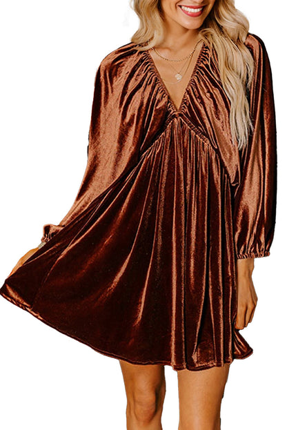 LuckeLadybug bronze velvet v neck mini dress with long bishop sleeves and swing skirt on smiling model