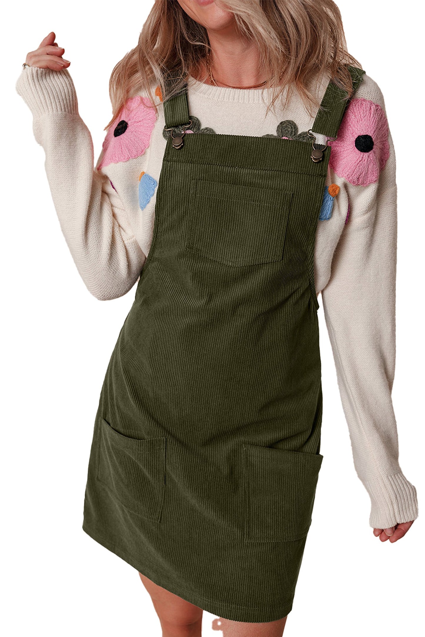 LuckeLadybug vineyard green corduroy overall dress with front pocket and side pockets styled over a floral sweater