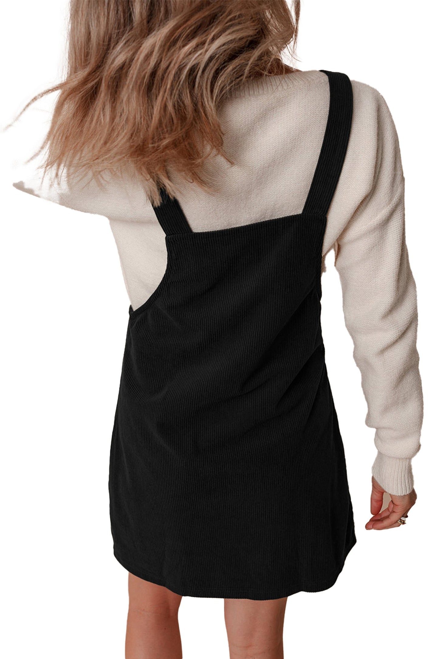 Back view of black corduroy mini overall dress by LuckeLadybug variant of vineyard green corduroy overall dress