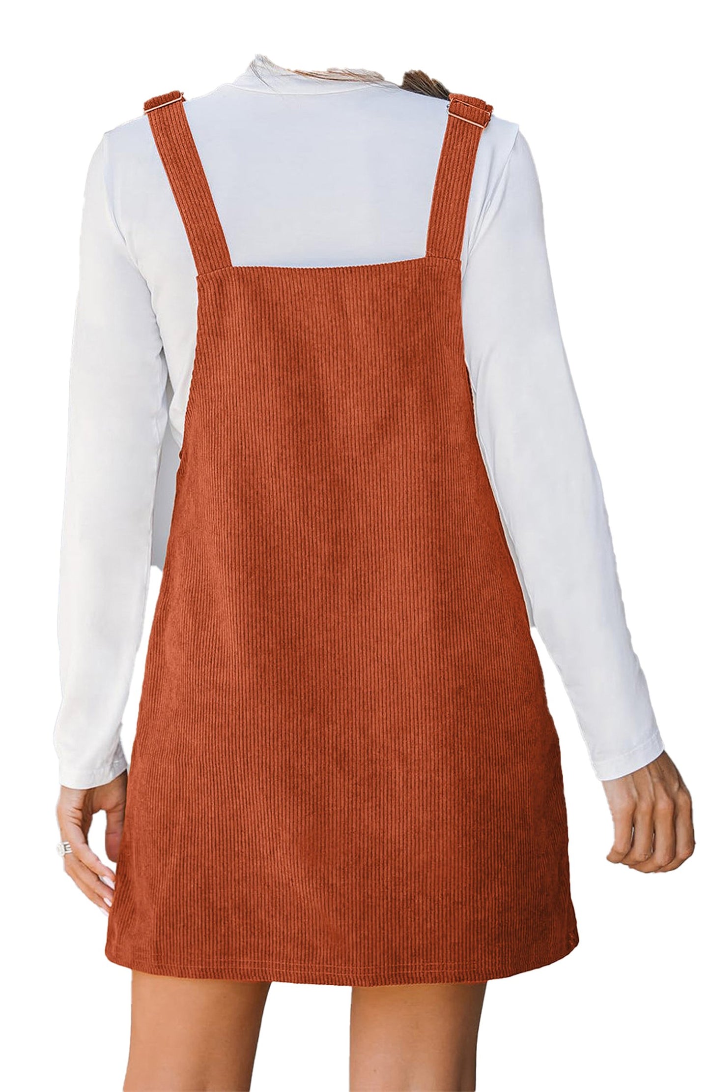 Back view of LuckeLadybug mini corduroy overall dress with adjustable straps over white tee vineyard green corduroy overall dress